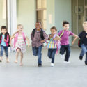 42109405 – group of elementary age schoolchildren running outside
