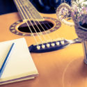 Guitar and notebook for love writing equipment with flower bucket.